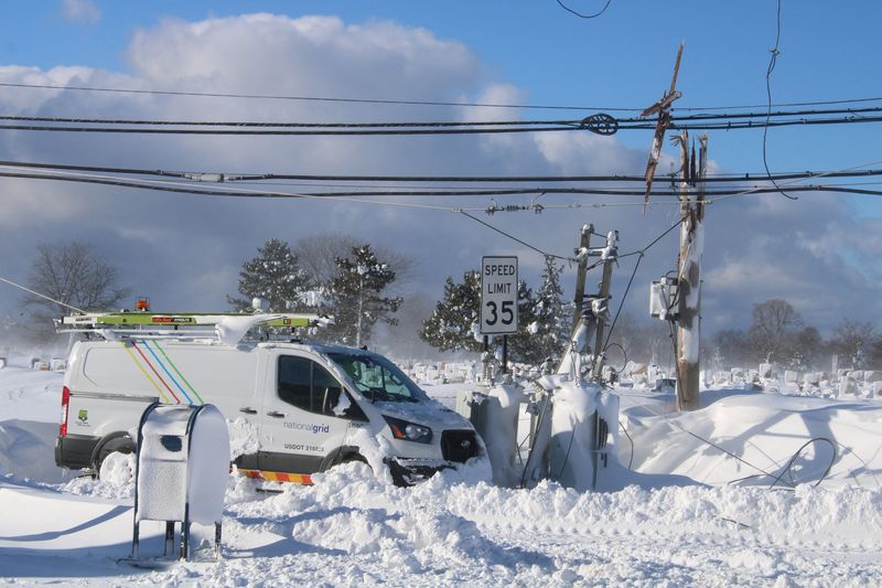 &copy; Reuters. FILE PHOTO: A vehicle from the National Grid is seen near the downed wires of an electric power pole, following a winter storm that struck the region, in Buffalo, New York, U.S December 25, 2022, in this picture obtained by Reuters from social media on De