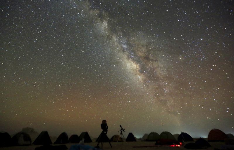 © Reuters. FILE PHOTO: The Milky Way is seen in the night sky around telescopes and camps of people over rocks in the White Desert north of the Farafra Oasis southwest of Cairo May 16, 2015. REUTERS/Amr Abdallah Dalsh/File Photo