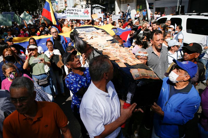 &copy; Reuters. FILE PHOTO: Teachers and health workers carry a mockup coffin covered in Bolivar bank notes during a protest demanding better wages, improved labor contracts and payment of bonuses, in Caracas, Venezuela January 11, 2023. REUTERS/Leonardo Fernandez Vilori