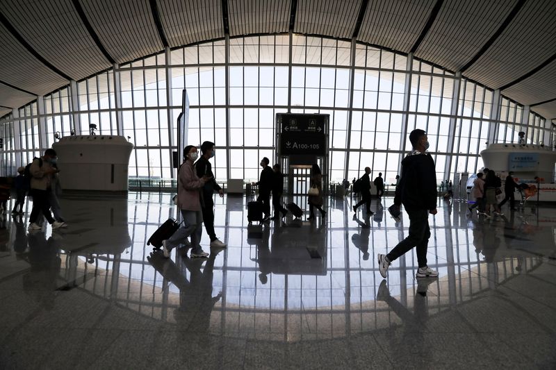&copy; Reuters. FILE PHOTO: Travellers are seen at the Beijing Daxing International Airport on the first day of Labour Day holiday, in Beijing, China May 1, 2021. REUTERS/Tingshu Wang/