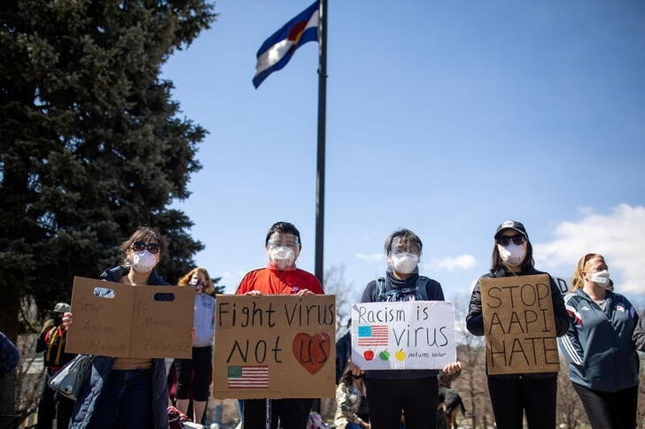 © Reuters. Illustrative: People hold signs as they gather at the Colorado State Capitol for a rally against anti-Asian hate crimes and to help heal as a community in Denver Colorado, U.S. March 27, 2021. REUTERS/Alyson McClaran