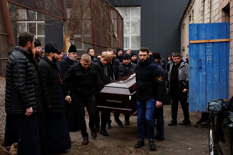 &copy; Reuters. Mykhailo Korenovskyi's, Ukrainian boxing coach and a father of two, killed during the Russian missile attack, coffin is carried on the day of his funeral,  in Dnipro, Ukraine January 17, 2023. REUTERS/Clodagh Kilcoyne