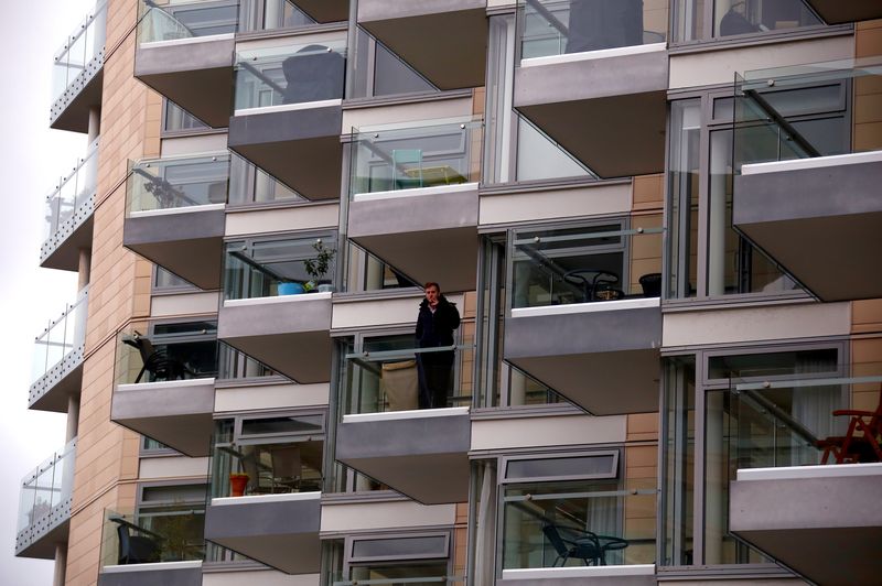&copy; Reuters. FILE PHOTO: A man smokes a cigarette on the balcony of a recently constructed residential apartment building in central Wellington, New Zealand, July 3, 2017.    REUTERS/David Gray