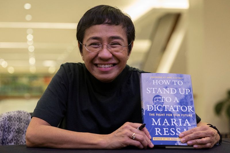 &copy; Reuters. FILE PHOTO: Nobel laureate Maria Ressa poses for a photo with her book "How to Stand Up to a Dictator: The Fight of our Future" during its launch in Pasig City, Metro Manila, Philippines, December 10, 2022. REUTERS/Eloisa Lopez