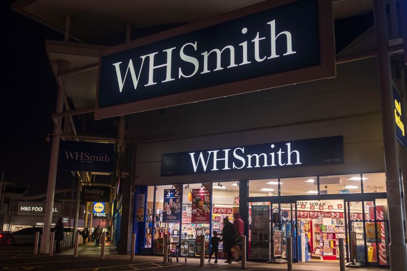 &copy; Reuters. FILE PHOTO: People pass through a branch of WH Smith in London, Britain, November 22, 2021. Picture taken November 22, 2021. REUTERS/May James