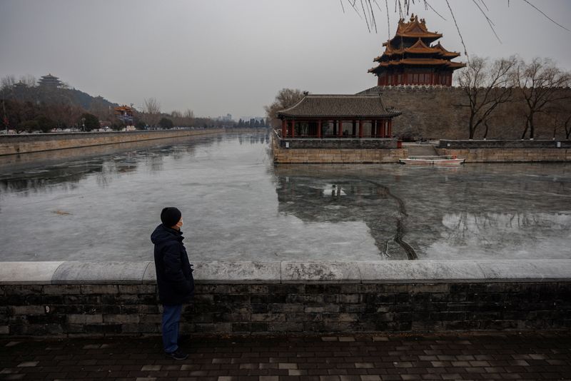 © Reuters. Beijing resident Zhang, 66, who lost four people close to him since early December as the coronavirus disease (COVID-19) cases spiked in China, poses for a picture at the Forbidden City in Beijing, China January 13, 2023. REUTERS/Thomas Peter