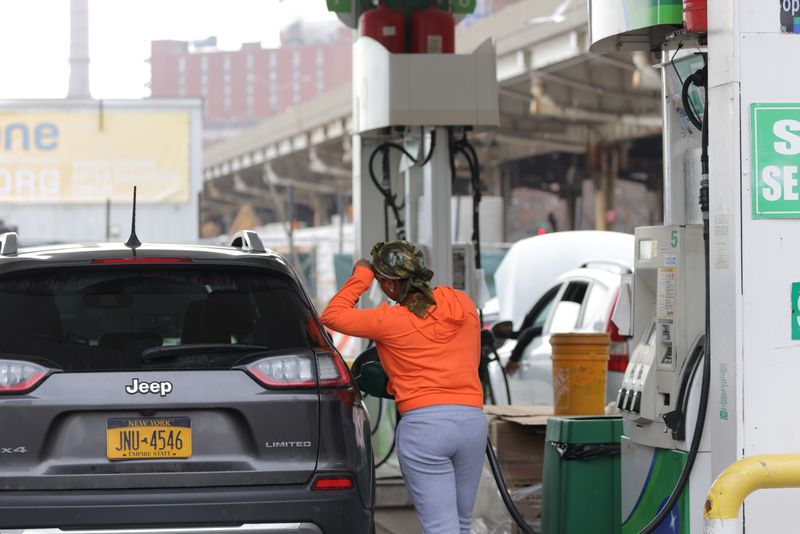 &copy; Reuters. A person uses a petrol pump at a gas station as fuel prices surged in Manhattan, New York City, U.S., March 7, 2022. REUTERS/Andrew Kelly