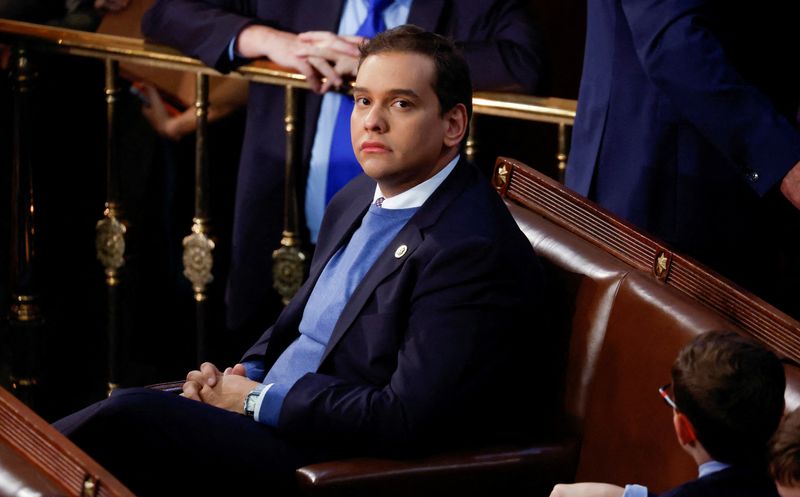 © Reuters. FILE PHOTO: Newly elected freshman Rep. George Santos (R-NY), embroiled in a scandal over his resume and claims made on the campaign trail, sits alone in the House Chamber surrounded only by the children of other representatives, on the first day of the 118th Congress at the U.S. Capitol in Washington, U.S., January 3, 2023. REUTERS/Jonathan Ernst/File Photo