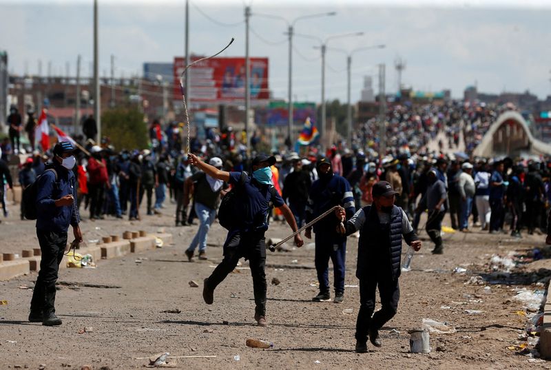 Thousands march on Peru's capital as unrest spreads, building set ablaze