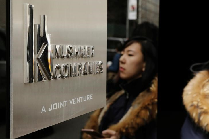 &copy; Reuters. A woman is reflected next to a sign on the building at 666 Fifth Avenue, owned by Kushner Companies, in New York, U.S., March 30, 2017.  REUTERS/Lucas Jackson
