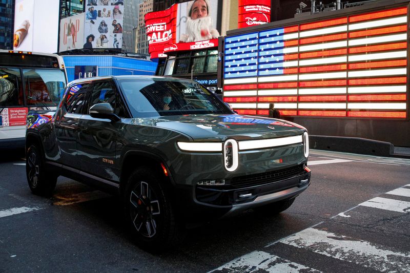 &copy; Reuters. FILE PHOTO: A Rivian R1T pickup, the Amazon-backed electric vehicle (EV) maker, is driven through Times Square during the company?s IPO in New York City, U.S., November 10, 2021. REUTERS/Brendan McDermid/File Photo
