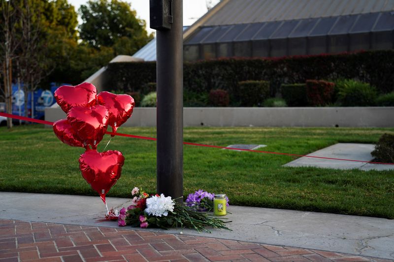 &copy; Reuters. Flowers and heart balloons are left near the scene of a shooting that took place during a Chinese Lunar New Year celebration, in Monterey Park, California, U.S. January 22, 2023.  REUTERS/Allison Dinner
