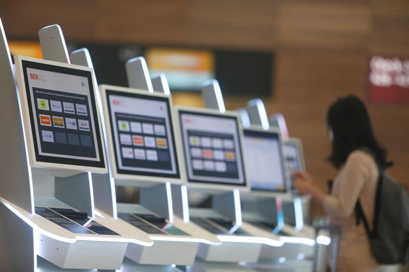 &copy; Reuters. FILE PHOTO: A passenger looks at a screen at Berlin Brandenburg Airport (BER), in Schoenefeld near Berlin, Germany, July 7, 2022. REUTERS/Michele Tantussi