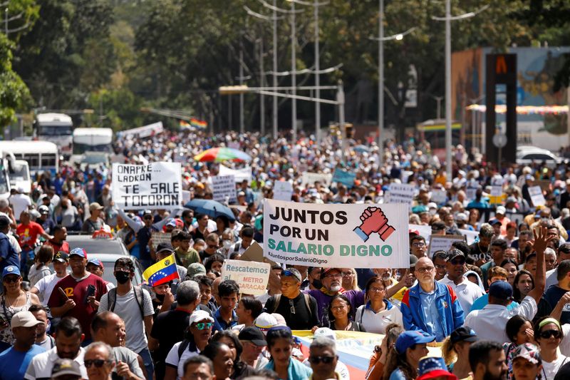 © Reuters. A demonstrator holds a placard that reads 