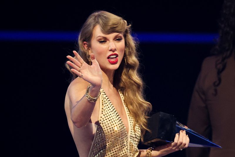 © Reuters. FILE PHOTO: Taylor Swift waves after receiving the Artist of the Year award during 2022 American Music Awards, at the Microsoft Theater in Los Angeles, California, U.S., November 20, 2022. REUTERS/Mario Anzuoni