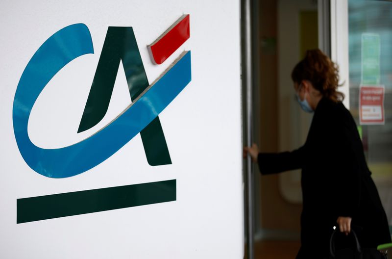 &copy; Reuters. FILE PHOTO-A woman walks past a Credit Agricole logo outside a bank office in Reze near Nantes, France, May 12, 2021. REUTERS/Stephane Mahe