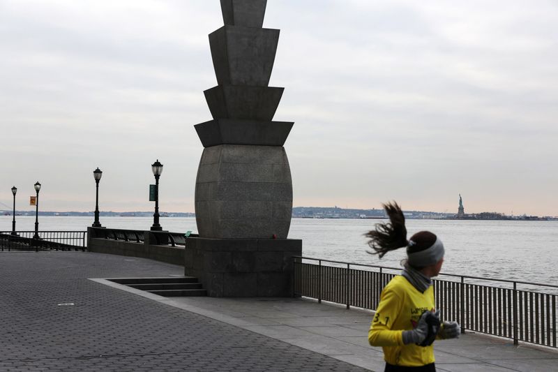 © Reuters. FILE PHOTO: The Statue of Liberty stands Liberty Island in New York Harbor as a woman jogs by in New York City, U.S., January 11, 2023.  REUTERS/Shannon Stapleton