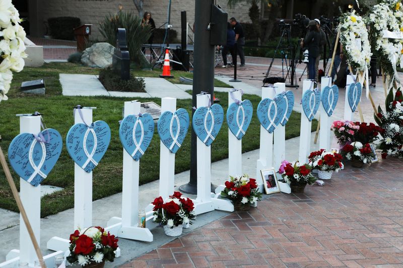 &copy; Reuters. FILE PHOTO: The names of the eleven people killed are written on hearts as people gather for a candlelight vigil after a mass shooting during Chinese Lunar New Year celebrations in Monterey Park, California, U.S. January 24, 2023.  REUTERS/David Swanson