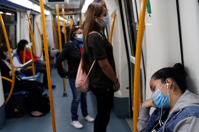 &copy; Reuters. FILE PHOTO: A commuter wearing a protective mask sleeps inside a metro coach, on the first day mask usage is mandatory in public transport, amid the coronavirus disease (COVID-19) outbreak in Madrid, Spain, May 4, 2020. REUTERS/Susana Vera