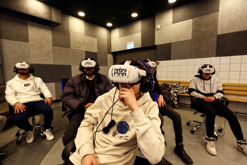 &copy; Reuters. A group participates in a virtual guided tour of the former Nazi German concentration camp Auschwitz-Birkenau and Polish Jewry before the Holocaust by using Virtual Reality headsets as part of an initiative named Triumph of the Spirit, that was developed 