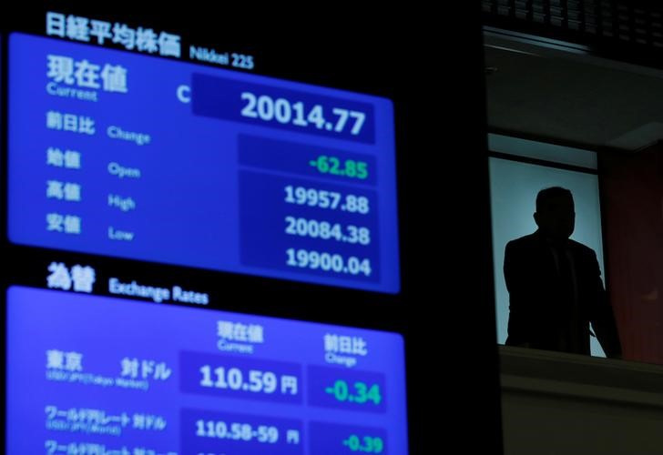 &copy; Reuters. Imagen de archivo de un hombre junto a una pantalla con cotizaciones en la Bolsa de Tokio, Japón. 28 diciembre 2018. REUTERS/Kim Kyung-Hoon