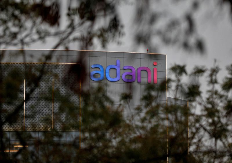 © Reuters. FILE PHOTO: The logo of the Adani Group is seen on the facade of its Corporate House on the outskirts of Ahmedabad, India, January 27, 2023. REUTERS/Amit Dave/File Photo