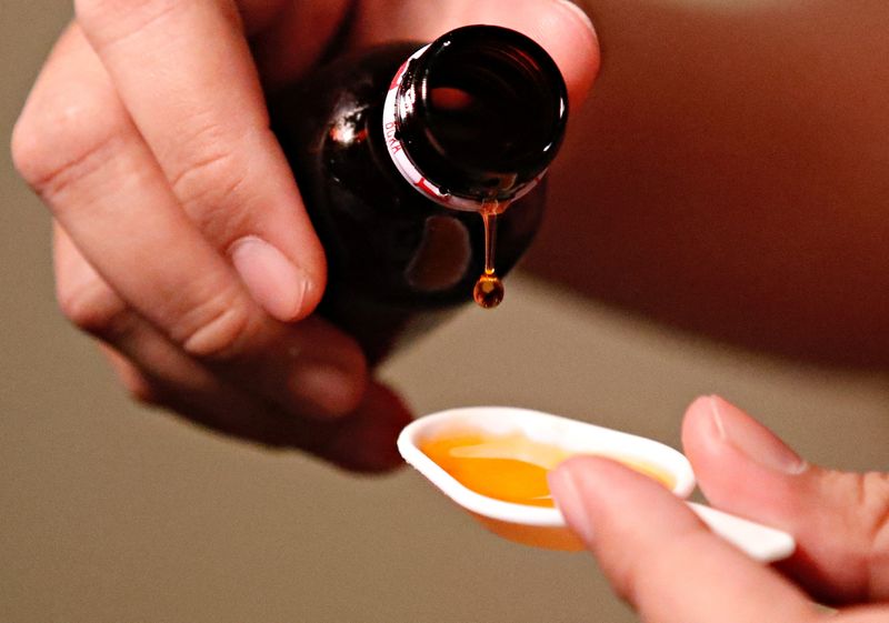 &copy; Reuters. FILE PHOTO: A cough medication is poured in this picture illustration taken October 19, 2022. REUTERS/Ajeng Dinar Ulfiana/Illustration