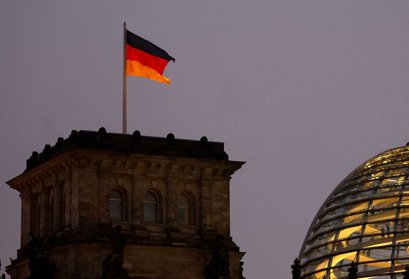 &copy; Reuters. FILE PHOTO: A German national flag flies atop the illuminated Reichstag building, the seat of Germany's lower house of parliament Bundestag, in Berlin, Germany December 9, 2022. REUTERS/Lisi Niesner