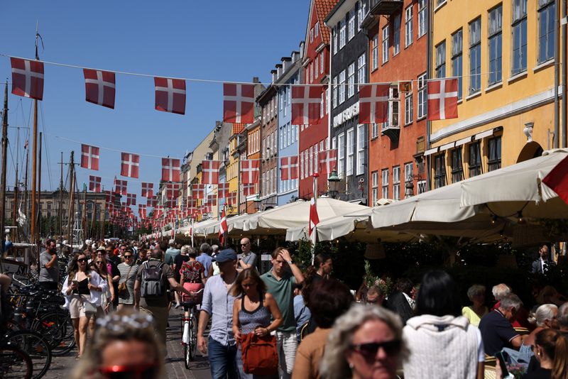 &copy; Reuters. FILE PHOTO: People walk as Danish flags are seen hung over Nyhavn in Copenhagen, Denmark, July 30, 2022. REUTERS/Andrew Kelly