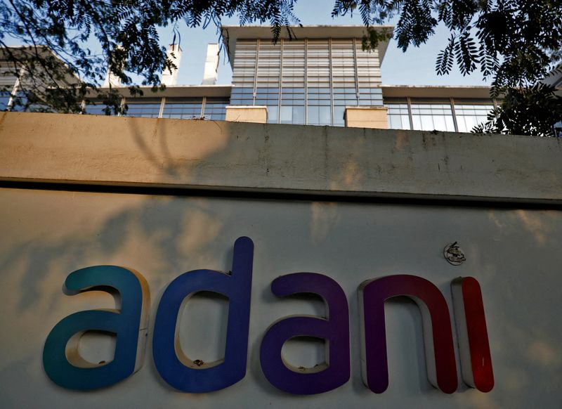 &copy; Reuters. FILE PHOTO: The logo of the Adani Group is seen on the wall of its realty office building on the outskirts of Ahmedabad, India, January 27, 2023. REUTERS/Amit Dave//File Photo