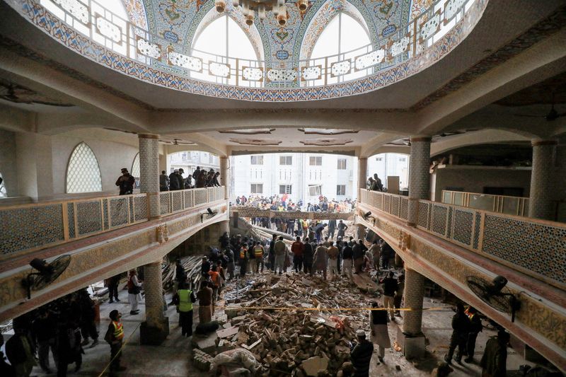 &copy; Reuters. People and rescue workers gather to look for survivors under a collapsed roof, after a suicide blast in a mosque in Peshawar, Pakistan January 30, 2023. REUTERS/Fayaz Aziz   