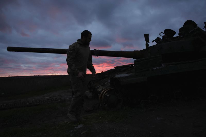 &copy; Reuters. FILE PHOTO: A Ukrainian serviceman walks near a destroyed tank at sunset, as Russia's invasion of Ukraine continues, near Izium, Ukraine, October 31, 2022. REUTERS/Clodagh Kilcoyne/File Photo