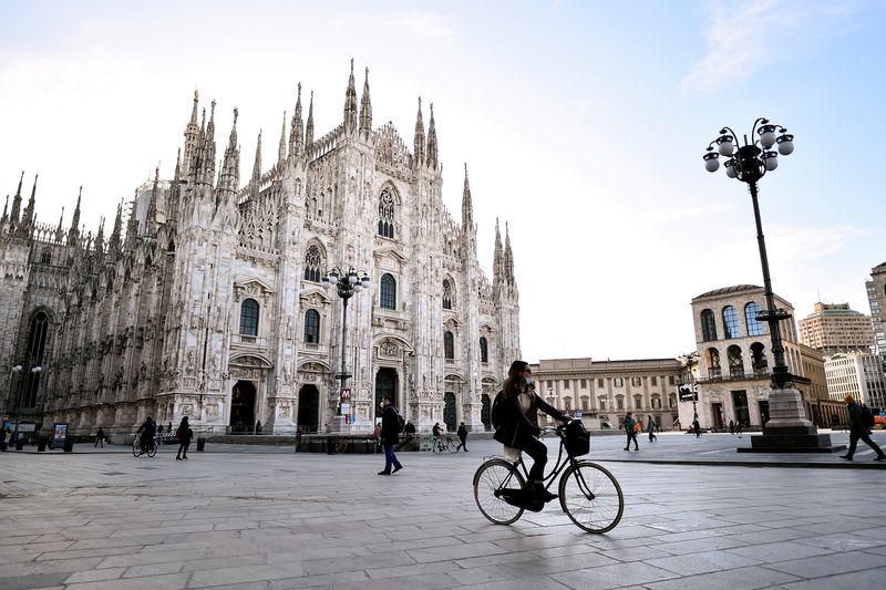 &copy; Reuters. FILE PHOTO: People wearing face masks walk in Duomo square as the region of Lombardy becomes a 'red zone', going into lockdown as the country struggles to reduce the coronavirus disease (COVID-19) infections, in Milan, Italy, March 15, 2021. REUTERS/Flavi