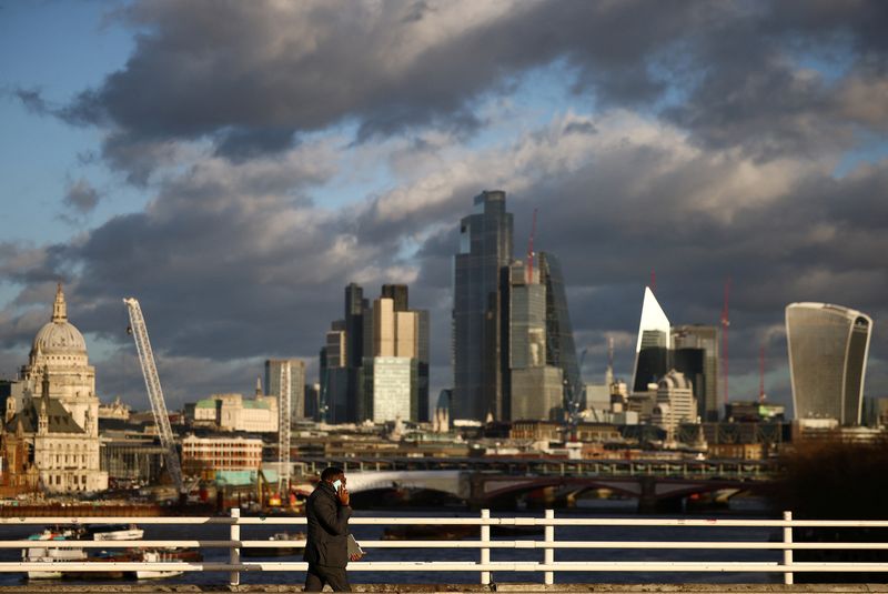 &copy; Reuters. FILE PHOTO: A person walks across Waterloo Bridge with the City of London financial district in the background, in London, Britain, January 13, 2023. REUTERS/Henry Nicholls