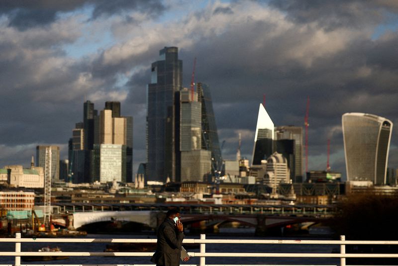 &copy; Reuters. FILE PHOTO: A person walks across Waterloo Bridge with the City of London financial district in the background, in London, Britain, January 13, 2023. REUTERS/Henry Nicholls/File Photo