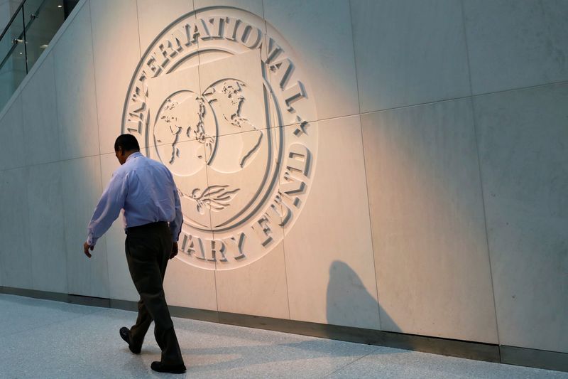 &copy; Reuters. FILE PHOTO: A man walks past the International Monetary Fund (IMF) logo at its headquarters in Washington, U.S., May 10, 2018. REUTERS/Yuri Gripas