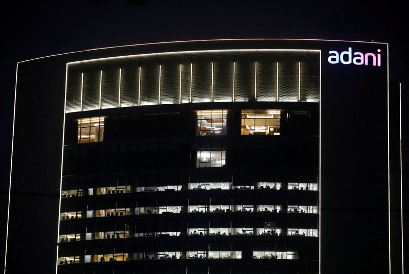 © Reuters. FILE PHOTO: The logo of the Adani Group is seen on the facade of its Corporate House on the outskirts of Ahmedabad, India, January 27, 2023. REUTERS/Amit Dave