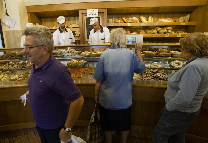 &copy; Reuters. FILE PHOTO: People wait to buy bread in a bakery in downtown Rome September 18, 2008. Consumer groups tried on Thursday to persuade Italians not to buy bread for a day, and to cut down on their consumption of other goods and services, to protest at price 