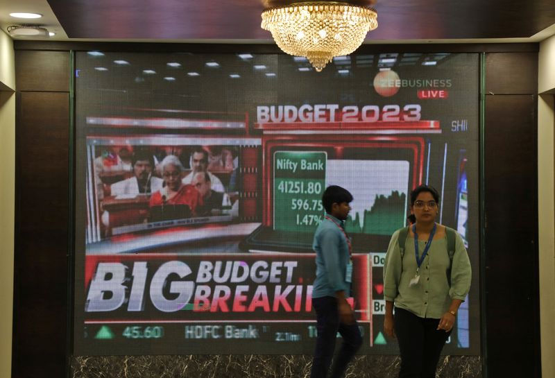 &copy; Reuters.  People walk past a telecast of India's Finance Minister Nirmala Sitharaman presenting the budget, inside the Bombay Stock Exchange (BSE) building in Mumbai, India, February 1, 2023. REUTERS/Niharika Kulkarni