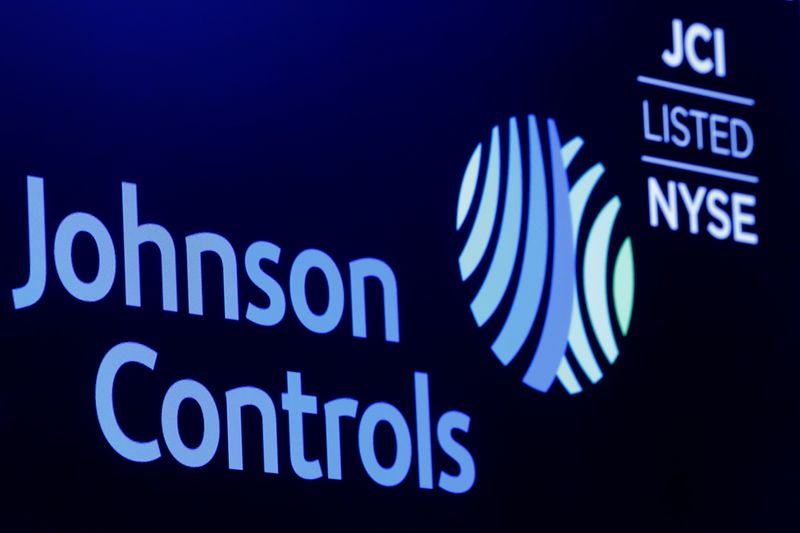 &copy; Reuters. FILE PHOTO: The logo and trading symbol for Johnson Controls International is displayed on a board on the floor of the New York Stock Exchange (NYSE) in New York, U.S., October 16, 2018. REUTERS/Brendan McDermid