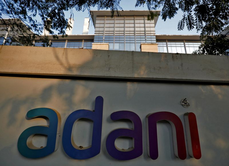 &copy; Reuters. FILE PHOTO: The logo of the Adani Group is seen on the wall of its realty office building on the outskirts of Ahmedabad, India, January 27, 2023. REUTERS/Amit Dave/File Photo