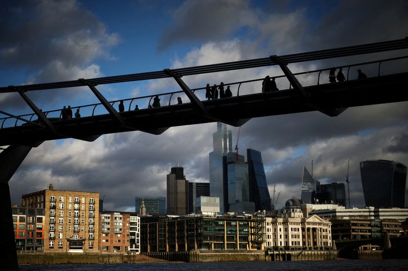 &copy; Reuters. FILE PHOTO: People walk over the Millennium Bridge with the City of London financial district in the background, in London, Britain, January 13, 2023. REUTERS/Henry Nicholls