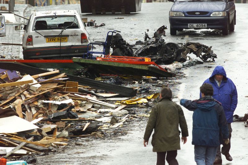 &copy; Reuters. FILE PHOTO: Security experts examine the charred remains of the vehicle thought to have contained the  bomb which exploded in Omagh's shopping area in Northern Ireland, August 16, 1998.  Reuters STR/File Photo