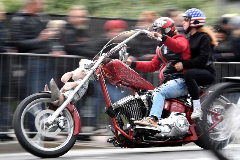 © Reuters. FILE PHOTO: A biker rides his Harley-Davidson during a parade at the 