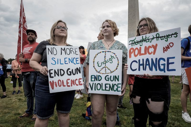 &copy; Reuters. FILE PHOTO: Demonstrators hold signs at "March for Our Lives", one of a series of nationwide protests against gun violence, in Washington, U.S., June 11, 2022. REUTERS/Ken Cedeno