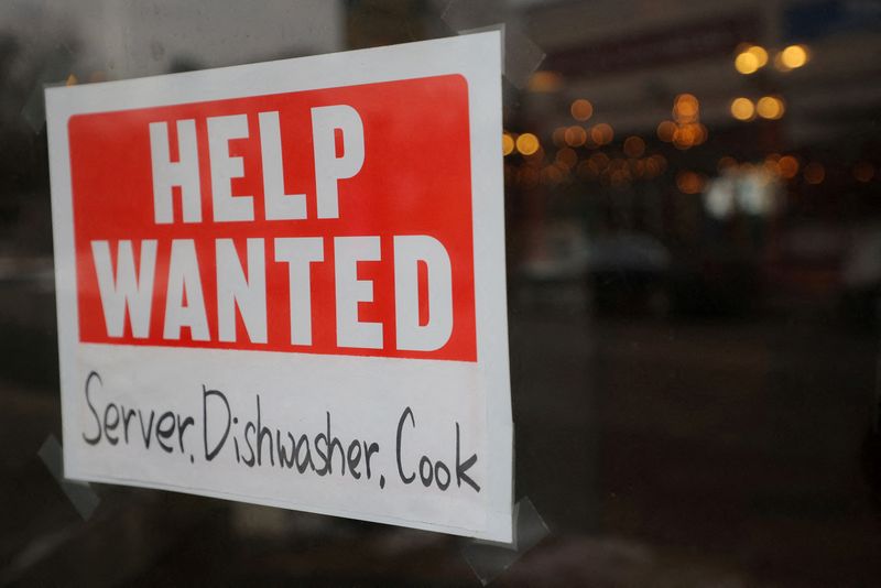 &copy; Reuters. FILE PHOTO: A ?Help Wanted? sign hangs in restaurant window in Medford, Massachusetts, U.S., January 25, 2023.     REUTERS/Brian Snyder/File Photo