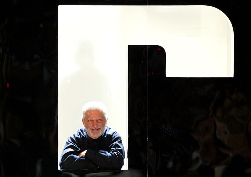 &copy; Reuters. FILE PHOTO: French designer Paco Rabanne poses after his Spring-Summer ready-to-wear women's fashion collection for 2004 in Paris, October 11, 2003.