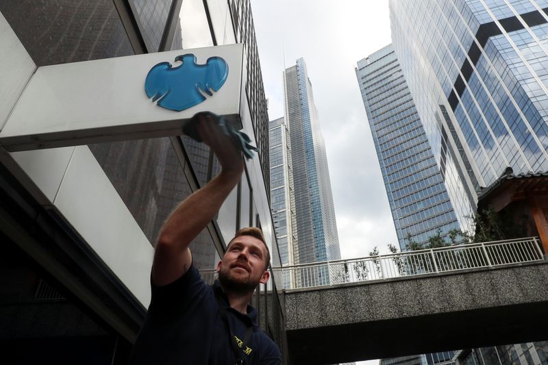 &copy; Reuters. FILE PHOTO: A worker cleans a Barclays logo outside a bank branch in the financial district of London, Britain July 8, 2019. REUTERS/Simon Dawson