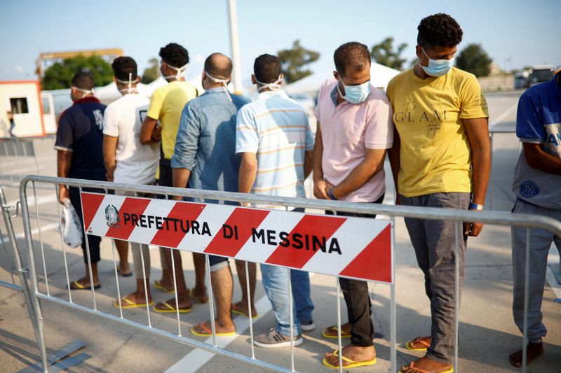 &copy; Reuters. FILE PHOTO: Migrants queue after disembarking from Open Arms rescue boat after arriving at Messina port, Sicily, Italy August 27, 2022. REUTERS/Juan Medina