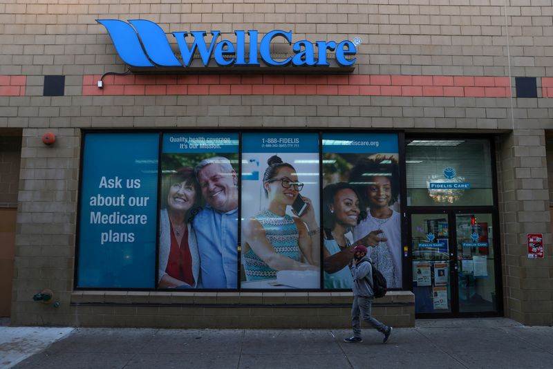 &copy; Reuters. FILE PHOTO: A person walks by a Wellcare and Fidelis Care location, part of the Centene Corporation, in Queens, New York, U.S., November 16, 2021. REUTERS/Andrew Kelly/File Photo